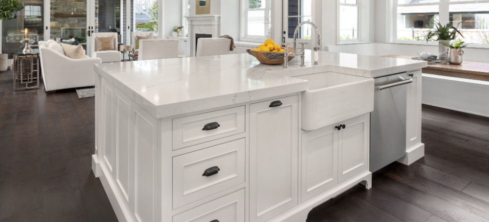 What holds a farmhouse sink in place?