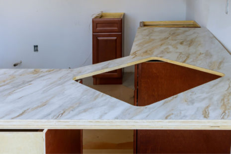 Should I remove my formica countertops or just put granite over the top of them?